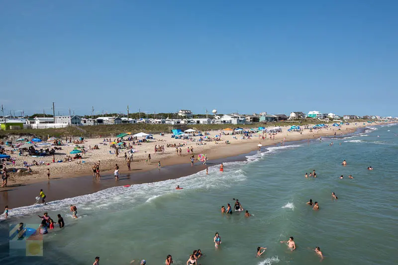 Swimmers and sun bathers next to Bogue Inlet Fishing Pier